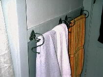 The towel racks have the leaf design to match the curtains.