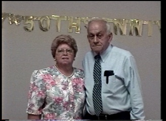 My parents in front of the banner.