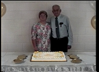 Mom and Dad pose with the beautiful cake.