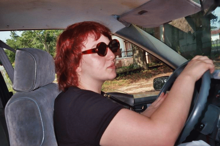 Laura driving in her cool shades