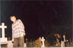 standing up out of a nafpaktian grave at night on the cemetery