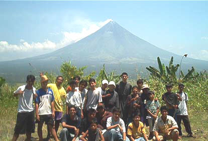 The group poses with the majestic Mayon Volcano at the background after a hike on a nearby hill