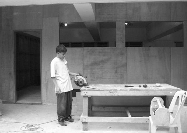 The transformation of the same basement hall into provisionary classrooms.