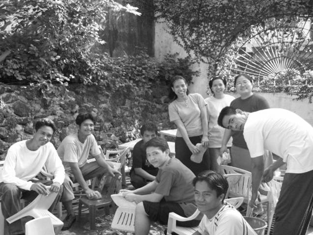 The teachers and volunteers help out in cleaning the plastic chairs and tables.