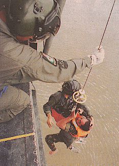 a 'rescued' pilot winched up to a hovering super puma