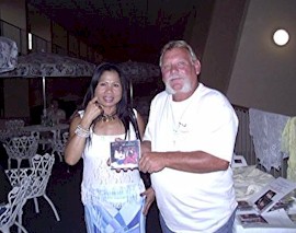 Mike Bradley of Debary, Florida buys a Thai music CD from Boonlue Middleton of San Diego, California