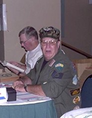 Woody Freeman from Valparaiso, Florida manning the registration desk at 2001 Reunion