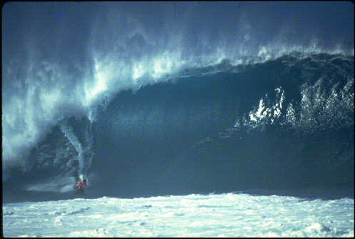 An unidentified sponger makes the most of Hawaii's Pipeline.