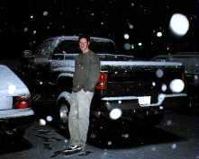 Patrick by his snow covered truck, 2000