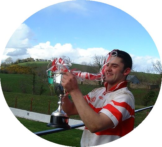 Glenfin captain, Mark McGinty proudly holding the McCully Cup