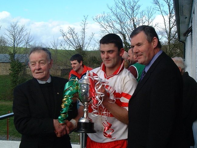 Glenfin captain, Mark McGinty proudly holding the McCully Cup