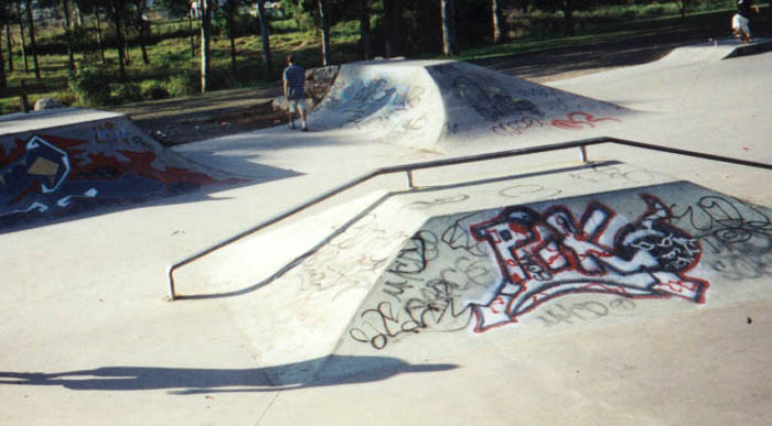 Grind rail on box, quarter to bank behind.