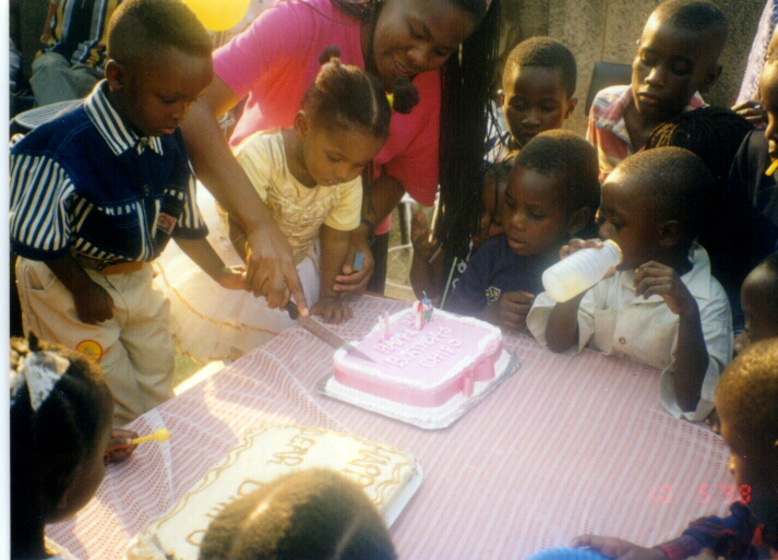 Chipo Mwiinga cutting her 2nd B/day cake with her friend Mumba