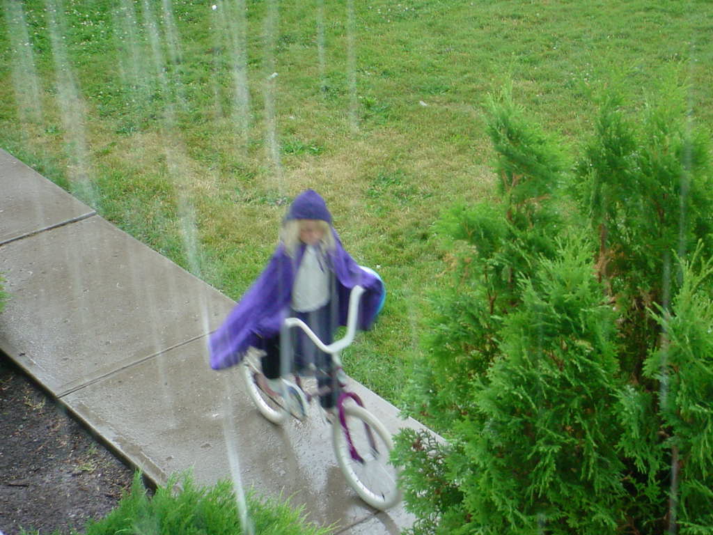 Ehreni riding her bike in the rain