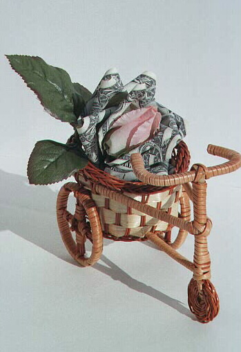 Rose bud on a tricylce, contains $5