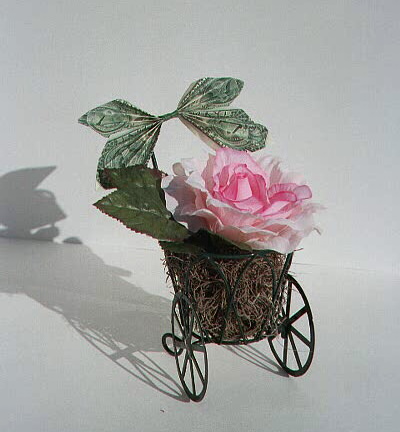 Rose in a wire cart, contains $2 