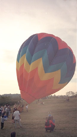 A hot air balloon getting set upright.