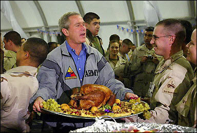 Pres. Bush carrying turkey