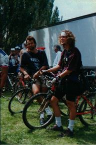 (2 riders standing with their bikes)