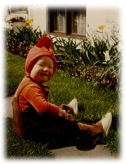 Me sitting in my grandfather's garden (one and a half years old)