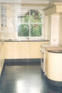 classic kitchen with stone coloured  cabinets and granite floor