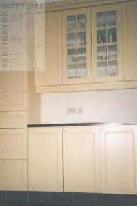 classic kitchen with stone coloured  cabinets and granite floor