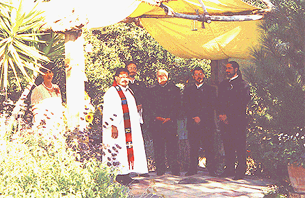 The men wait in the gazebo.