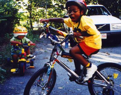 Jack and Desi on bikes.  [34 kb]