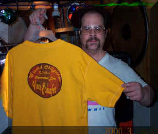 Music T-shirts are good advertising for this electronic music project, featuring Vince Schaefer! Pictured holding a popular design, from the Wizard Obligation album. 