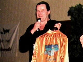 Geoff shows off the "Drama Tour of the Americas 1980" jacket that he donated for the auction.