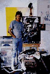 Paul in his studio with one of the paintings being shown in his exhibition in Germany