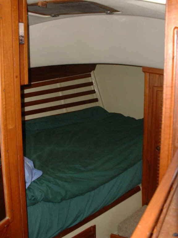 Double berth featuring custom built spring mattress. Two screened opening ports and hatch.