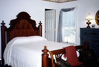 The grand mahogany bed in the Captain's Room