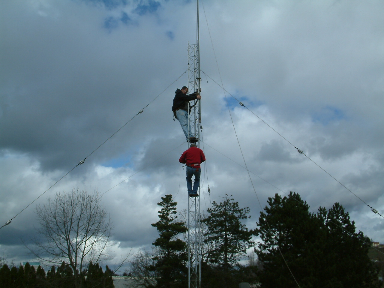 2 people climbing the tower (from a distance)