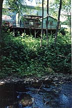 VIEW OF CREEK AND CABIN