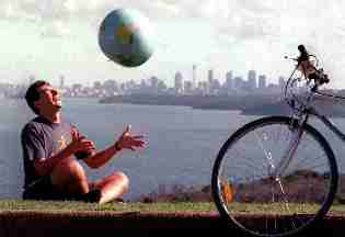 Rob controlling the world - badly - in front of the skyscrapers of Sydney and the harbour