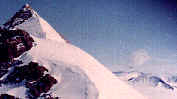 Quartzite peaks have snowy north, rocky south faces.