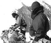 Well-wrapped Evan and John preparing belay equipment.