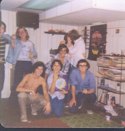 Kevin Hay kneeling with blue shirt and glasses