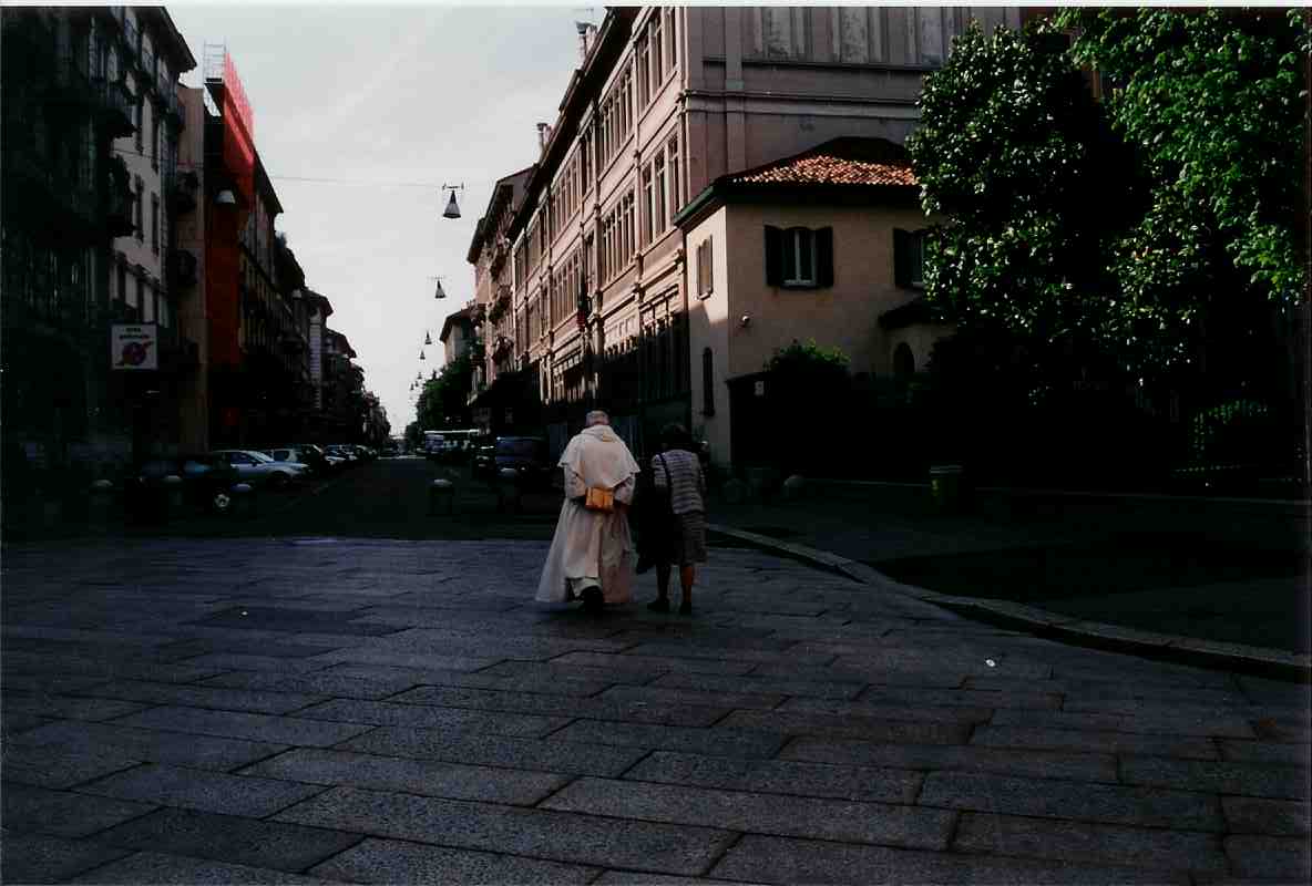 Milano - Priest and Woman walking at Cenacolo Vinciano