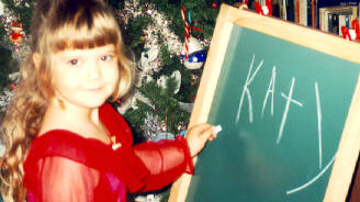 Pic of Katy Writing her Name on a Chalk Board