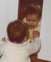 child looking into a mirror