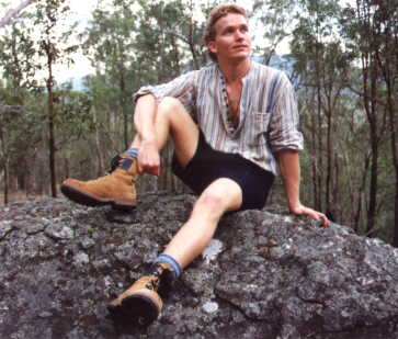 Malcolm sitting on a rock