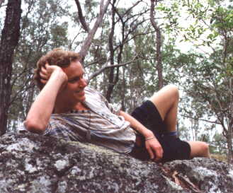 Malcolm laying on a rock