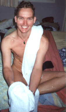 Malcolm bare on a bed after a bath