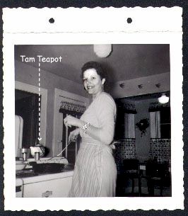 Martha cooking breakfast with a Tam O'Shanter teapot in the background.