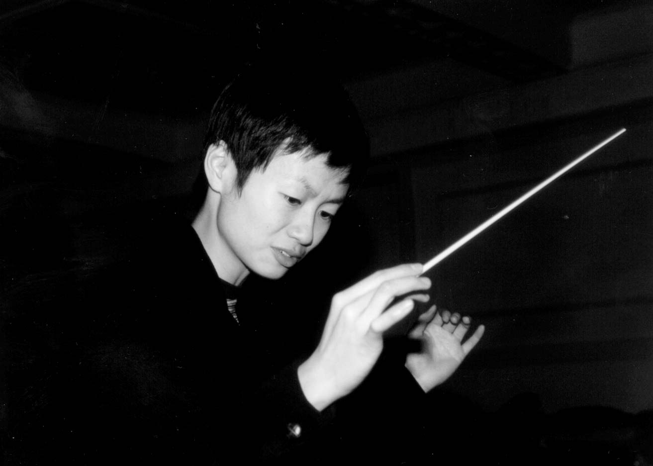 Judy Yan conducting with her baton.