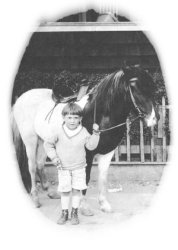 Young Warren posing on horse.