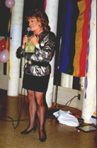 Photo of me speaking with Rainbow flag in background