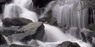 Photo of a river flowing thru rock